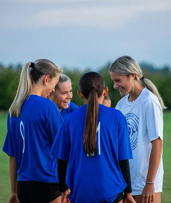 Girls smiling in huddle