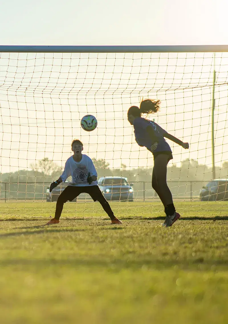 Teen boy and girl practicing soccer