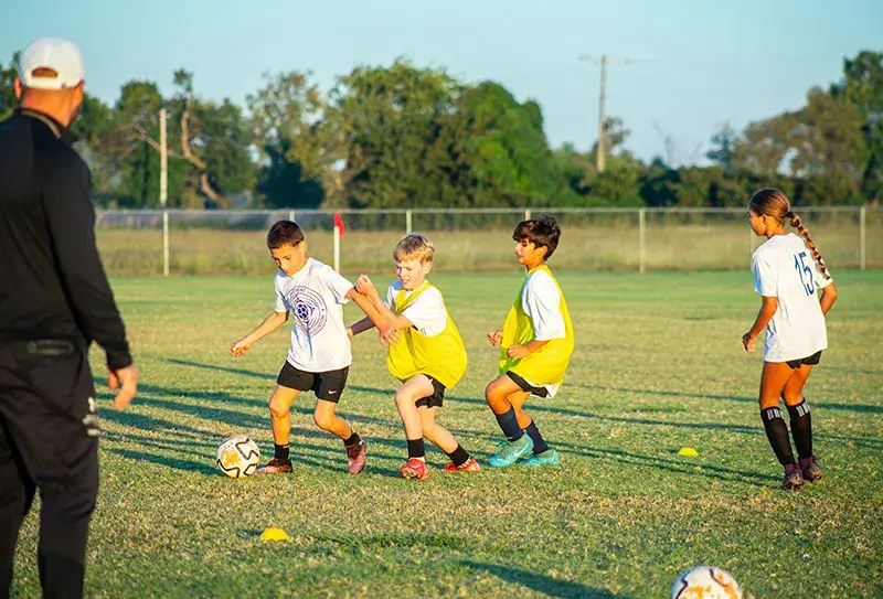 Young boys and girls playing soccer